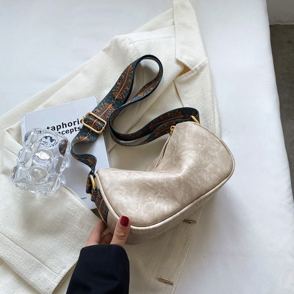 Crossbody bags with embroidered handle